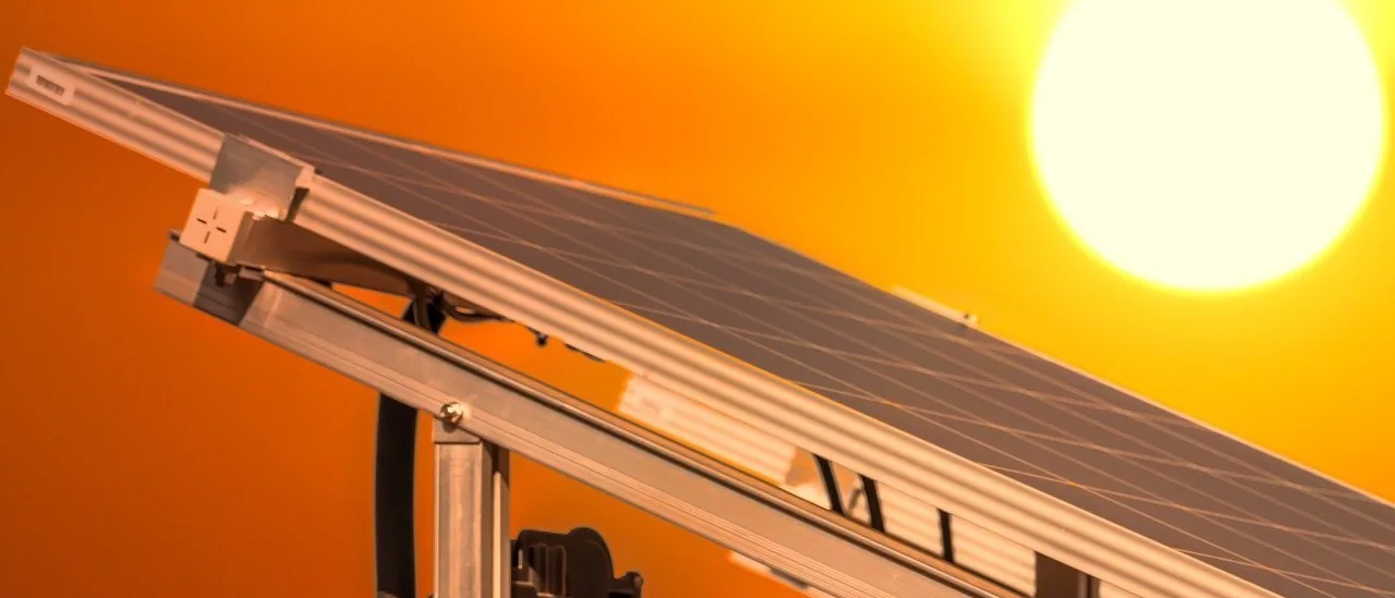 A solar array against a low orange sun