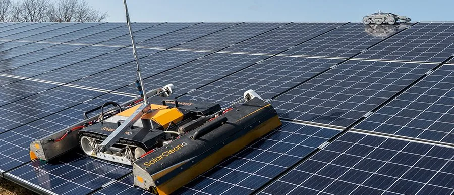 A cleaning robot working its way along a row of solar modules